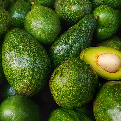 Bunch,Of,Green,Avocados.,One,Of,Them,Is,Opened,That